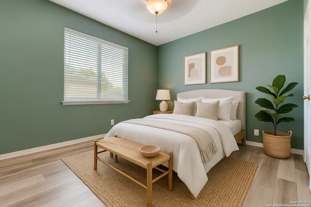 a view of a room that has a window and wooden floor
