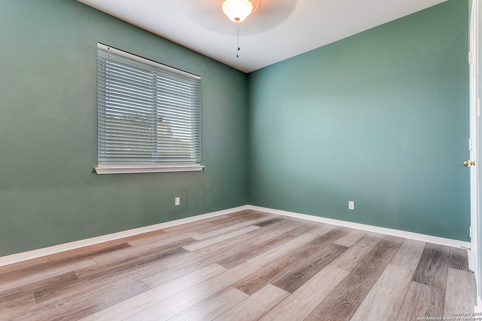 112 Spring Fawn Cibolo, TX 78108 - Photo 21 of 26 a view of a room that has a window and wooden floor