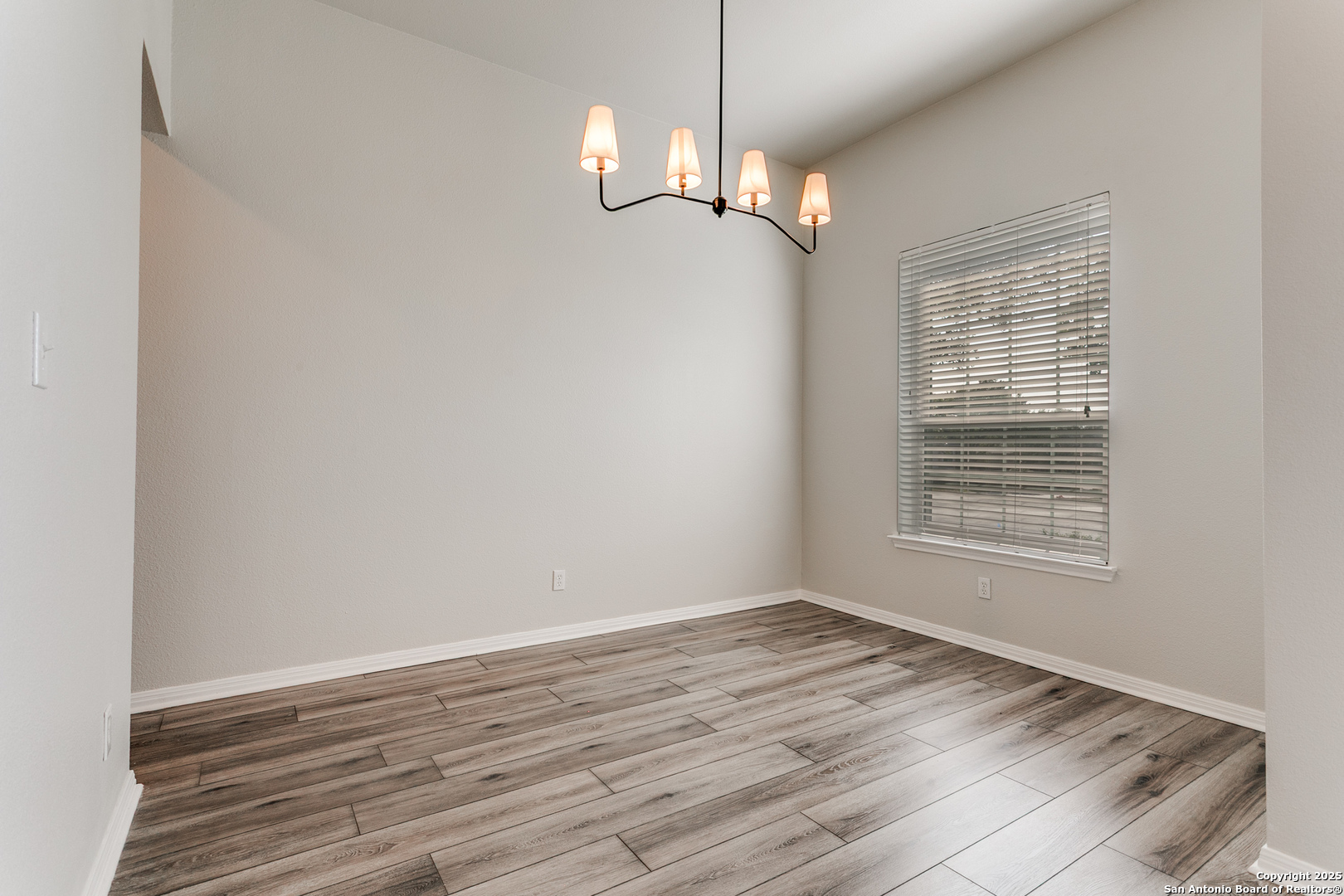 112 Spring Fawn Cibolo, TX 78108 - Photo 10 of 26 wooden floor in an empty room with a window