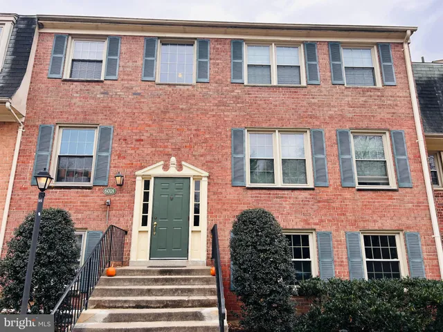 a living room with fireplace and a floor to ceiling window