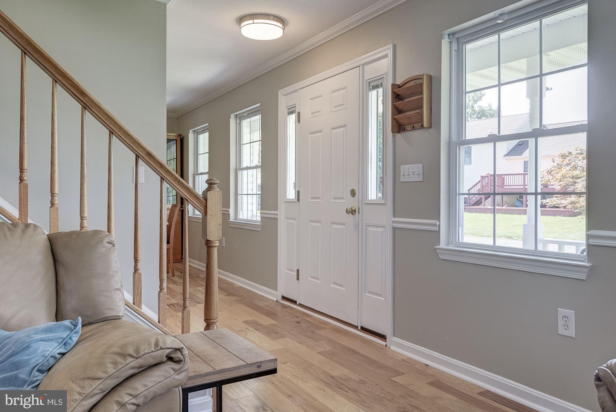 8702 Winands Road Randallstown, MD 21133 - Photo 2 of 32 a view of a hallway with furniture and a window