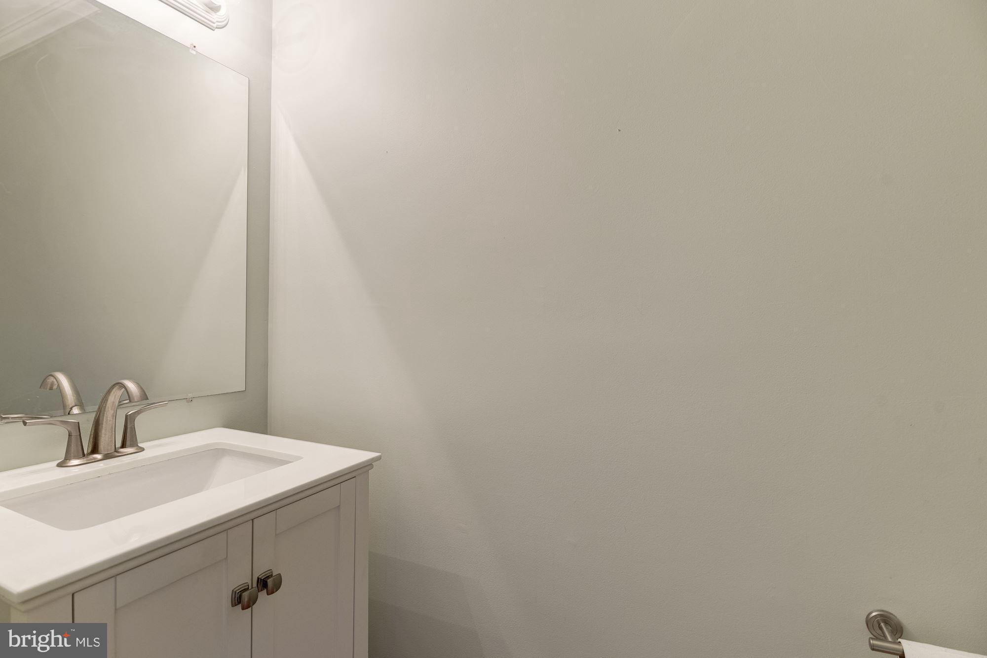 8702 Winands Road Randallstown, MD 21133 - Photo 12 of 32 a bathroom with a sink and mirror