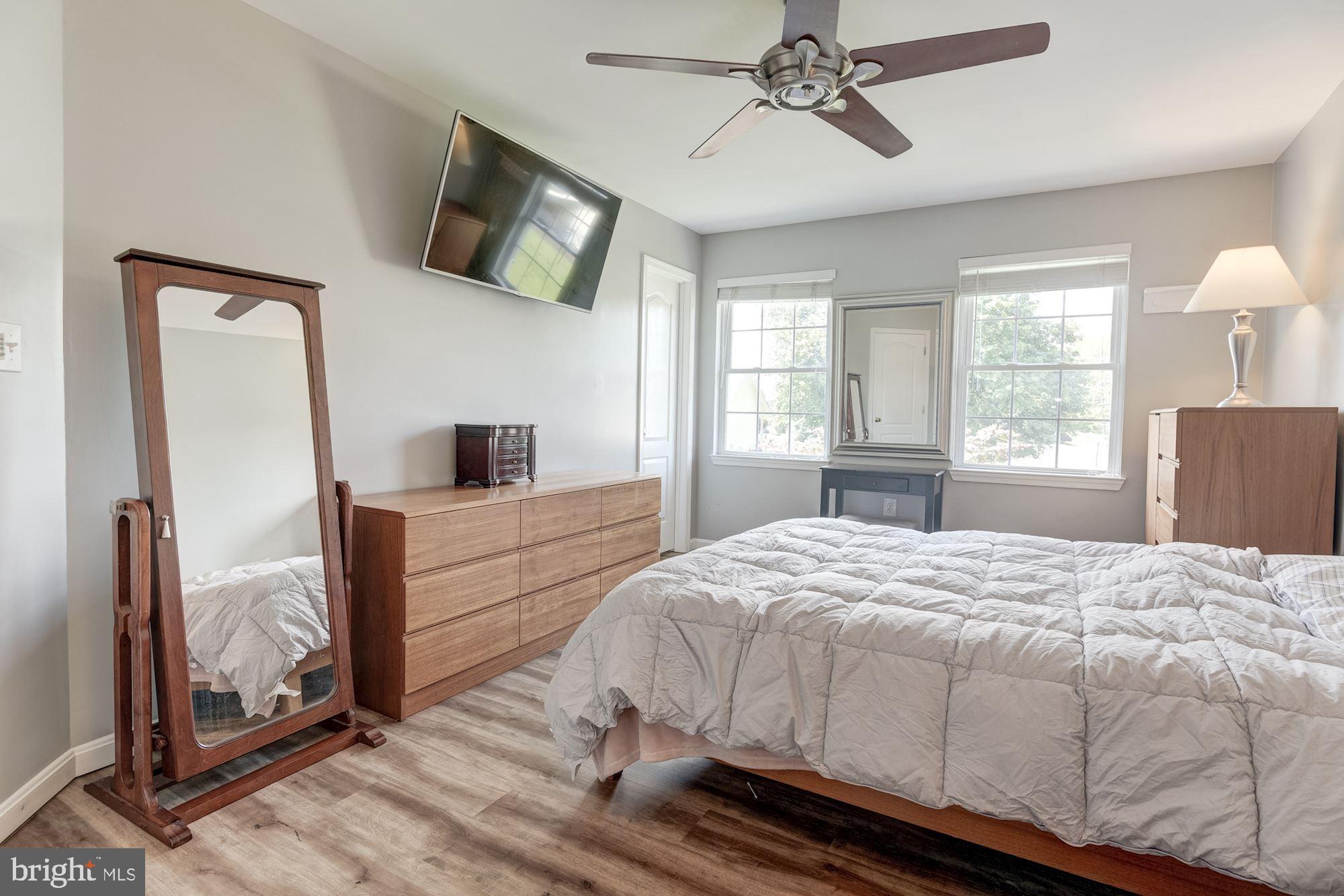 8702 Winands Road Randallstown, MD 21133 - Photo 14 of 32 a bedroom with a bed and a flat screen tv