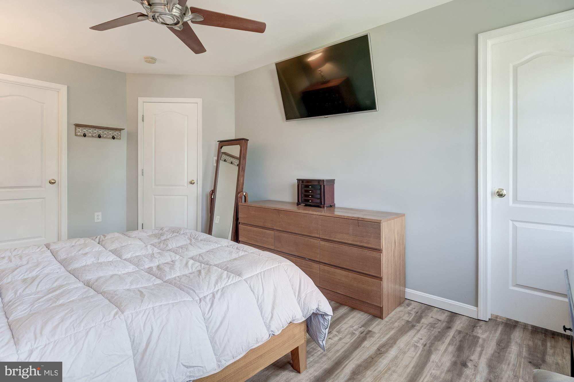 8702 Winands Road Randallstown, MD 21133 - Photo 15 of 32 a bedroom with a bed and a flat screen tv
