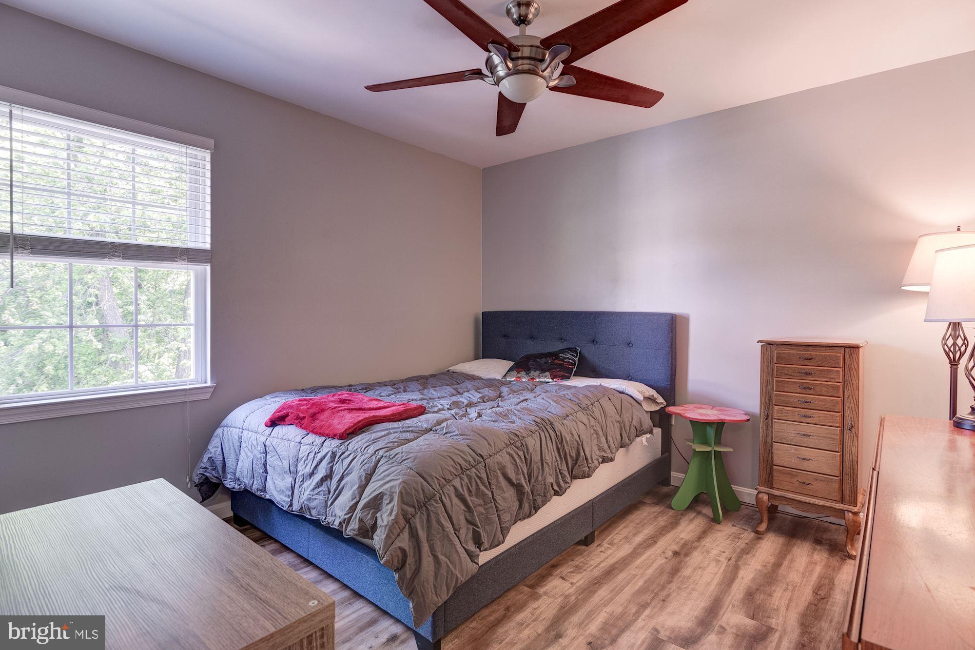 8702 Winands Road Randallstown, MD 21133 - Photo 20 of 32 a bedroom with a bed a dresser and a window