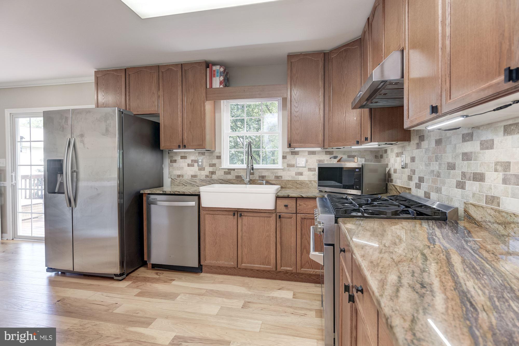 8702 Winands Road Randallstown, MD 21133 - Photo 9 of 32 a kitchen with a sink stove and refrigerator