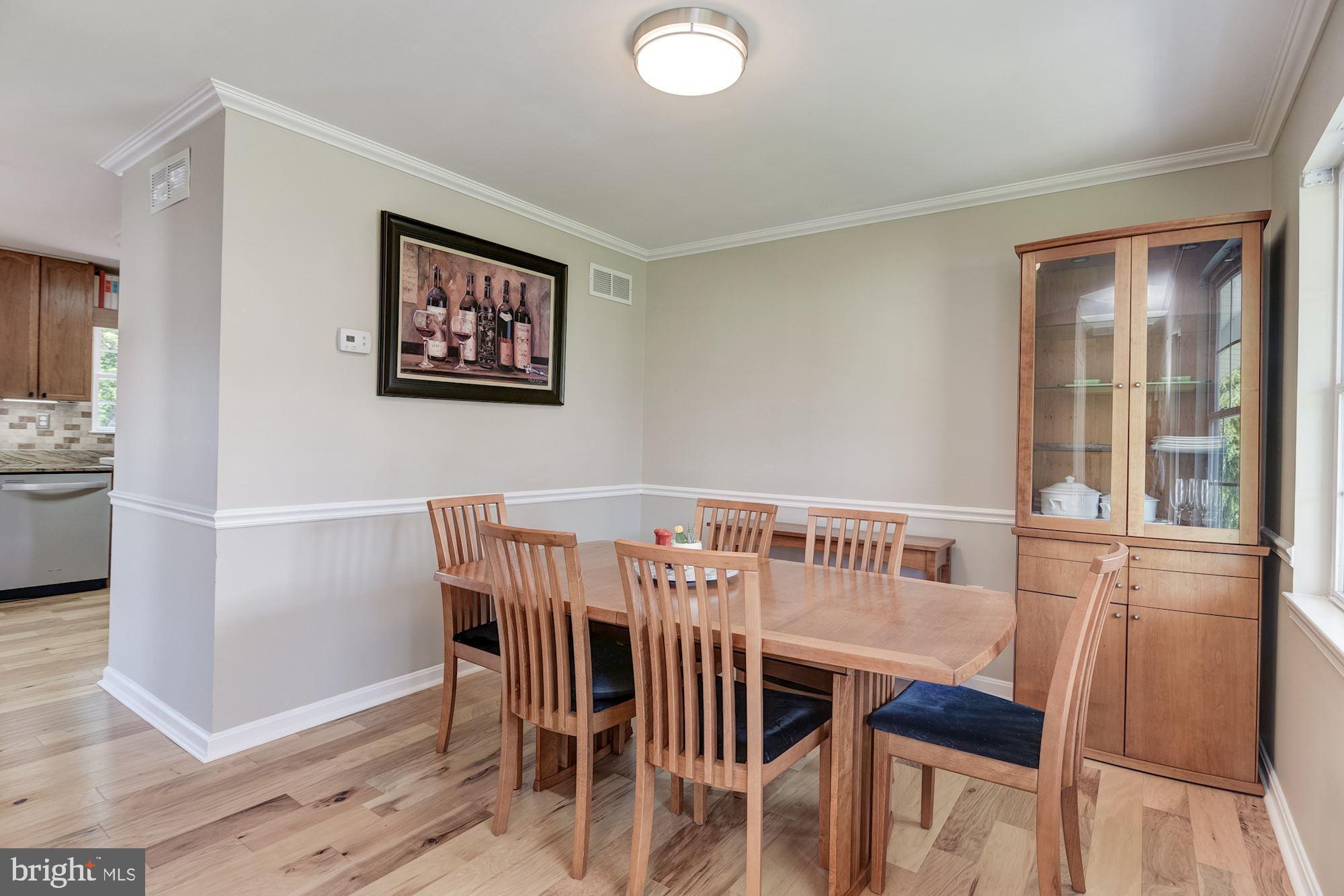 8702 Winands Road Randallstown, MD 21133 - Photo 10 of 32 a view of a dining room with furniture and wooden floor