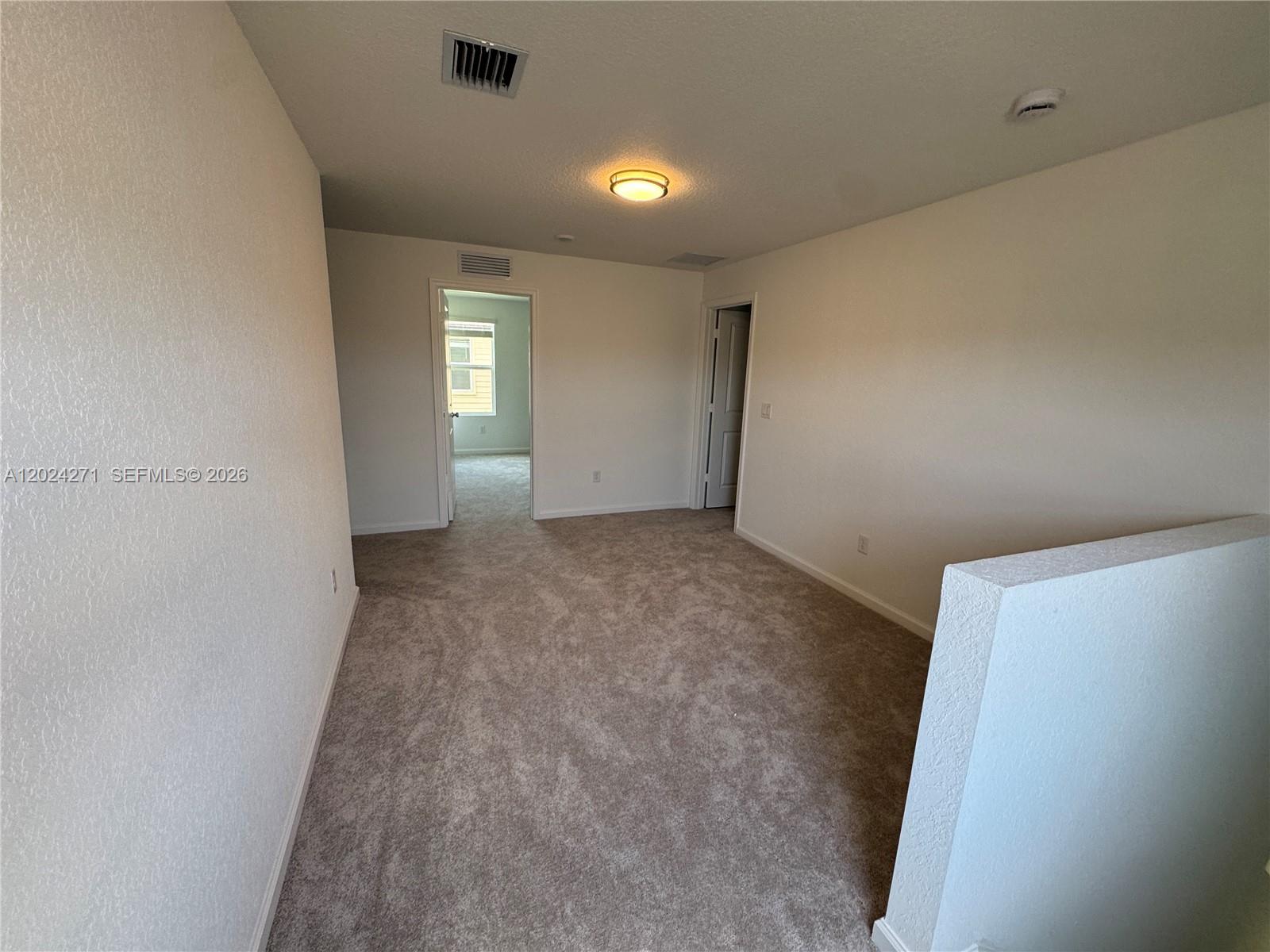 693 Carlyle Way Fort Pierce, FL 34947 - Photo 15 of 19 wooden floor in an empty room with a window