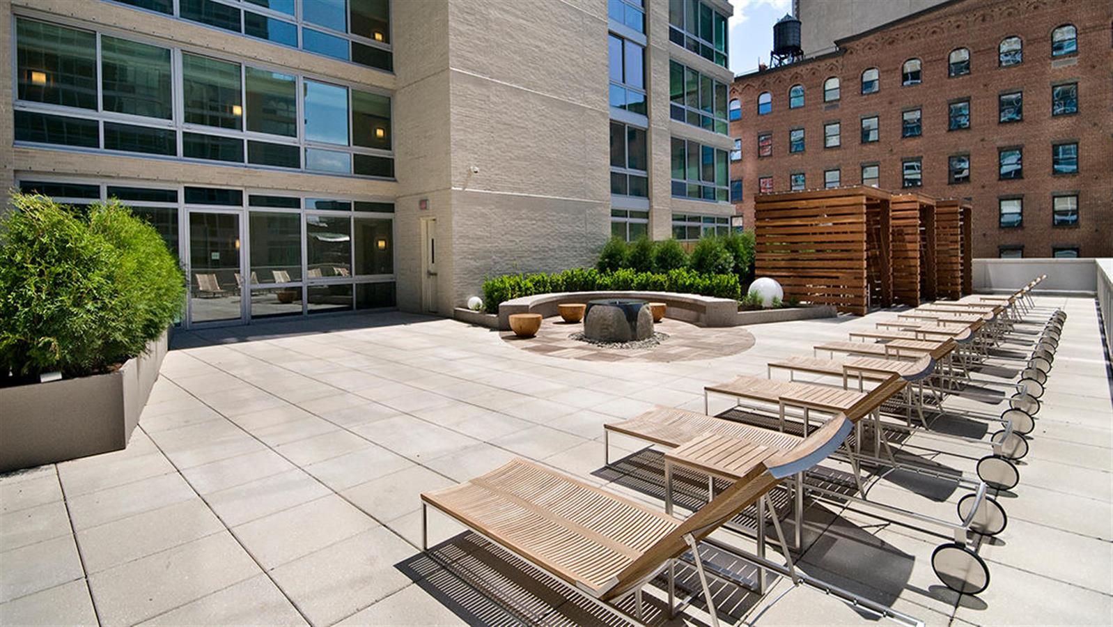 505 West 37th Street, Unit 25H Manhattan, NY 10018 - Photo 5 of 13 a view of a patio with table and chairs and potted plants