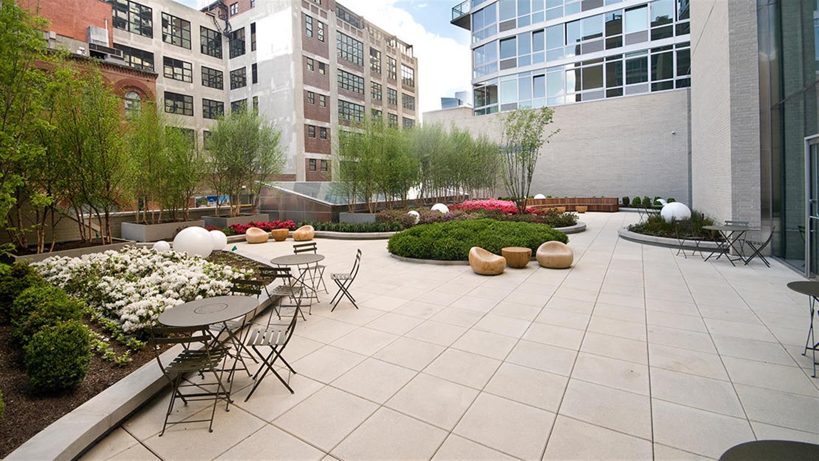 505 West 37th Street, Unit 25H Manhattan, NY 10018 - Photo 6 of 13 a view of a patio with dining table and chairs and potted plants