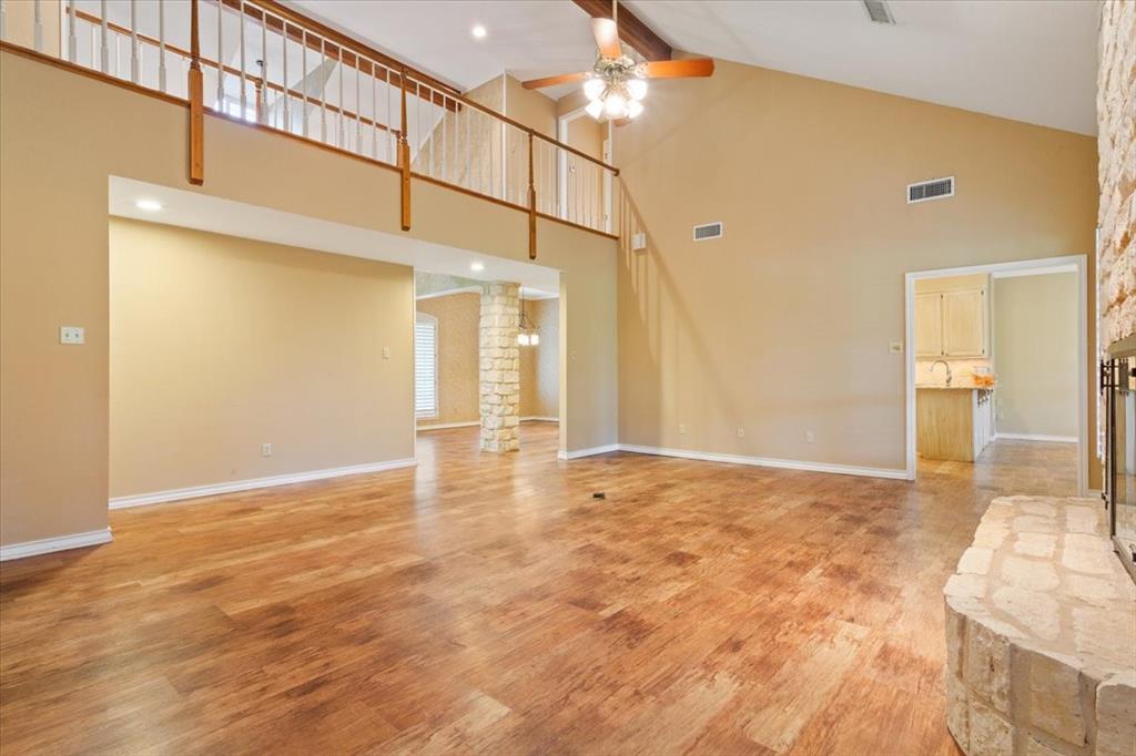 4843 South 3rd St Road Waco, TX 76706 - Photo 11 of 39 Unfurnished living room featuring high vaulted ceiling, a ceiling fan, visible vents, and ornate columns