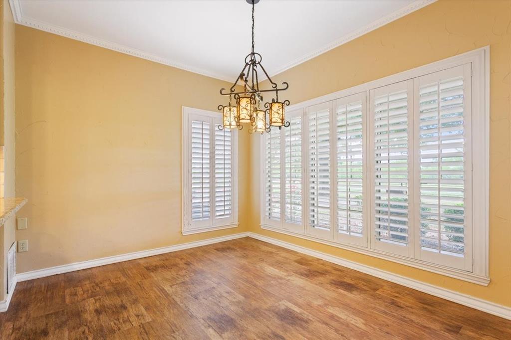 4843 South 3rd St Road Waco, TX 76706 - Photo 12 of 39 Unfurnished dining area featuring an inviting chandelier, crown molding, wood finished floors, and baseboards