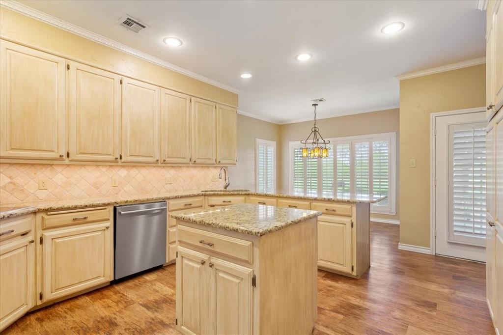 4843 South 3rd St Road Waco, TX 76706 - Photo 13 of 39 Kitchen with backsplash, dishwasher, light wood-type flooring, crown molding, and a peninsula