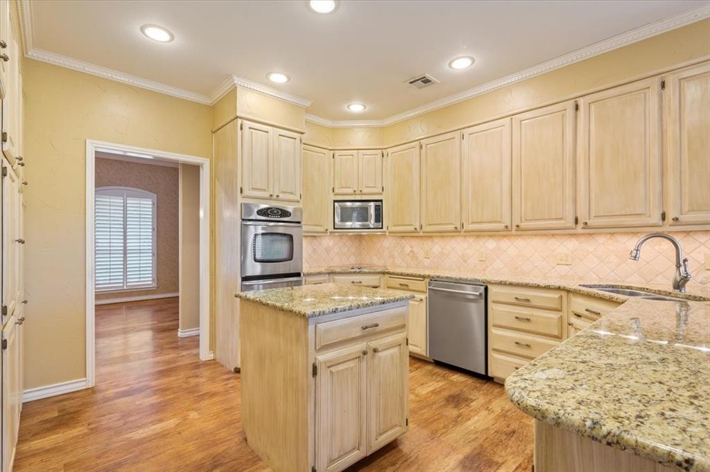 4843 South 3rd St Road Waco, TX 76706 - Photo 15 of 39 Kitchen featuring a sink, light brown cabinetry, stainless steel appliances, light stone countertops, and visible vents