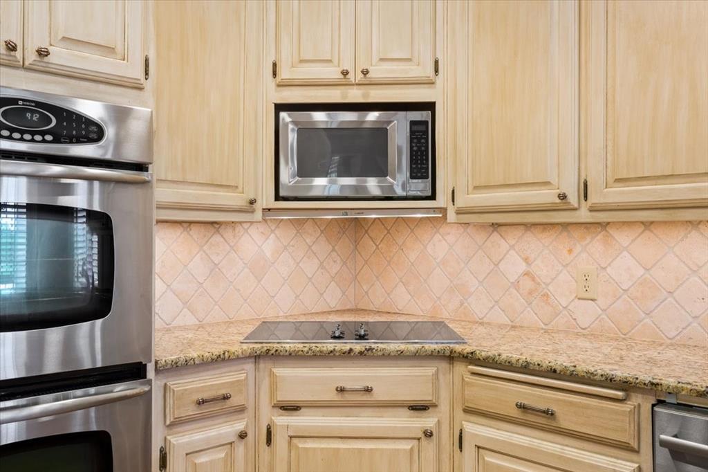 4843 South 3rd St Road Waco, TX 76706 - Photo 16 of 39 Kitchen with light stone countertops, light brown cabinetry, appliances with stainless steel finishes, and tasteful backsplash
