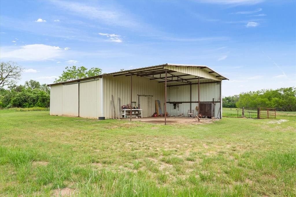 4843 South 3rd St Road Waco, TX 76706 - Photo 33 of 39 View of pole building featuring a yard and fence