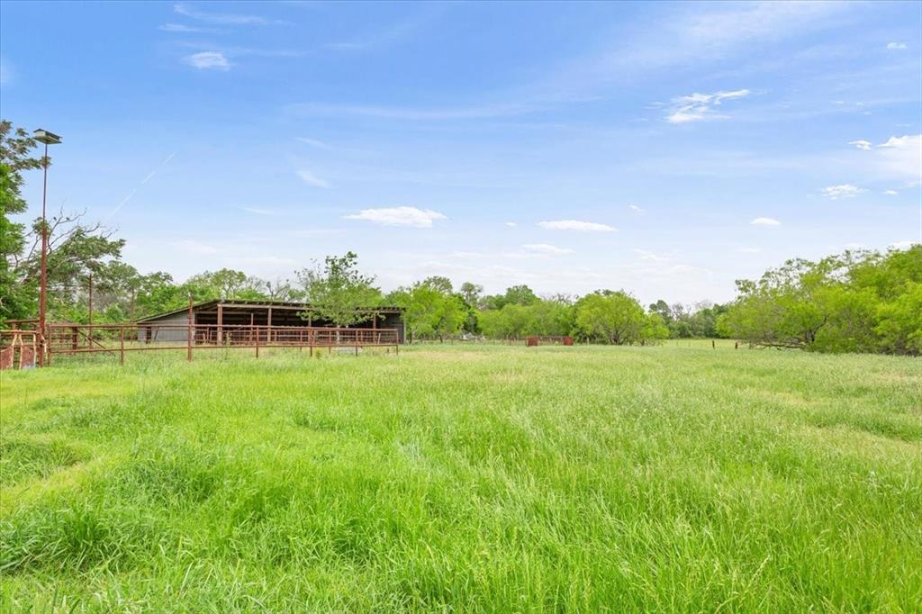 4843 South 3rd St Road Waco, TX 76706 - Photo 34 of 39 View of yard with fence, an outbuilding, and a rural view
