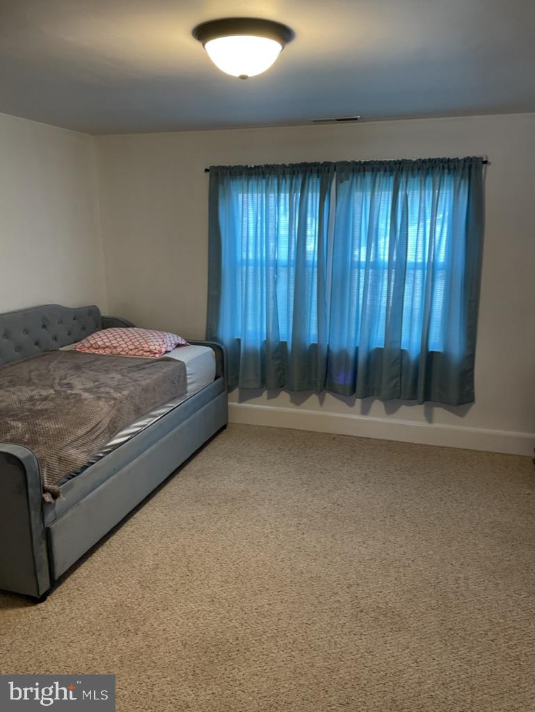 305 North Main Street Hurlock, MD 21643 - Photo 11 of 20 a bed sitting in a room next to a window
