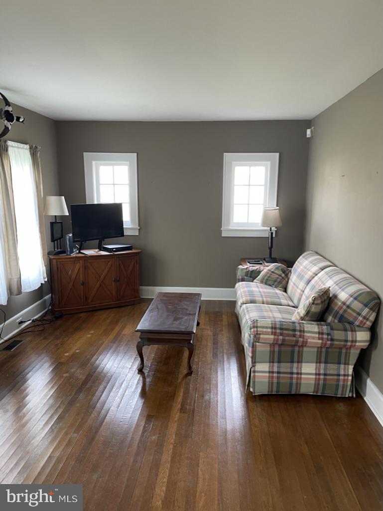 305 North Main Street Hurlock, MD 21643 - Photo 2 of 20 a living room with furniture and a flat screen tv