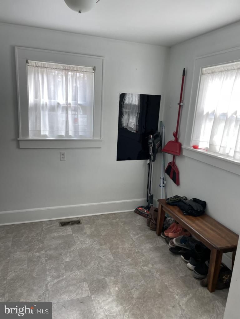 305 North Main Street Hurlock, MD 21643 - Photo 5 of 20 a room with gym equipment and a flat screen tv