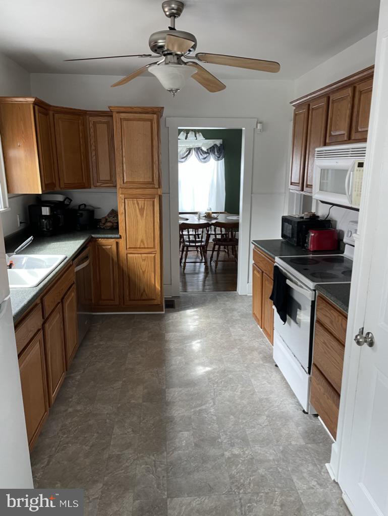 305 North Main Street Hurlock, MD 21643 - Photo 6 of 20 a kitchen with a stove a refrigerator and cabinets