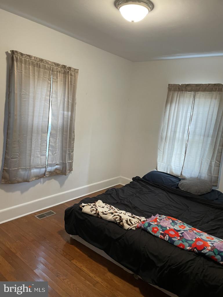 305 North Main Street Hurlock, MD 21643 - Photo 8 of 20 a bedroom with a bed window and flowerpot