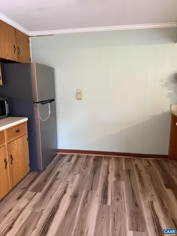 a view of a room with wooden floor