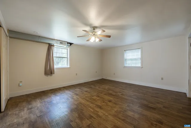 a view of a hallway with closet and a window