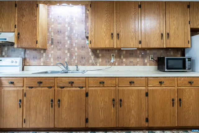 an empty room with closet and windows