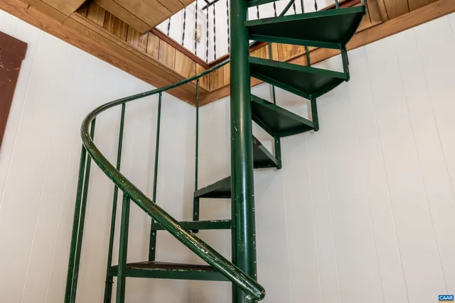 a view of a hallway with a chandelier and wooden floor
