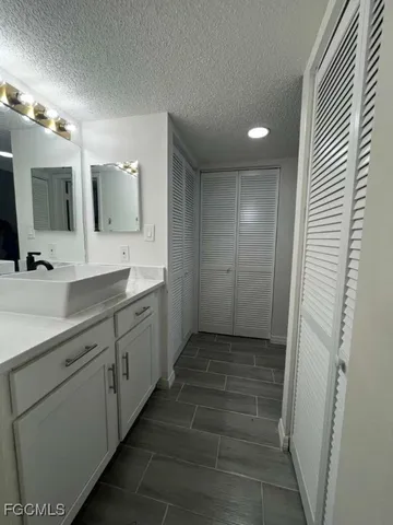 a bathroom with a double vanity sink and a mirror