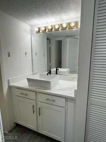 a bathroom with a double vanity sink and mirror