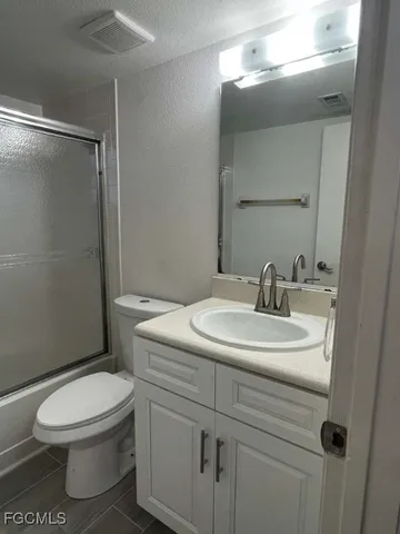 a bathroom with a sink a toilet and mirror