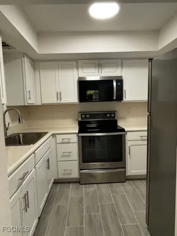 a kitchen with a stove and a microwave