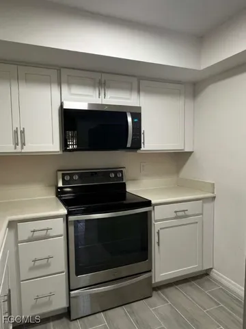 a kitchen with stainless steel appliances a stove a microwave and cabinets