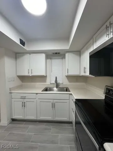 a kitchen with a sink and cabinets