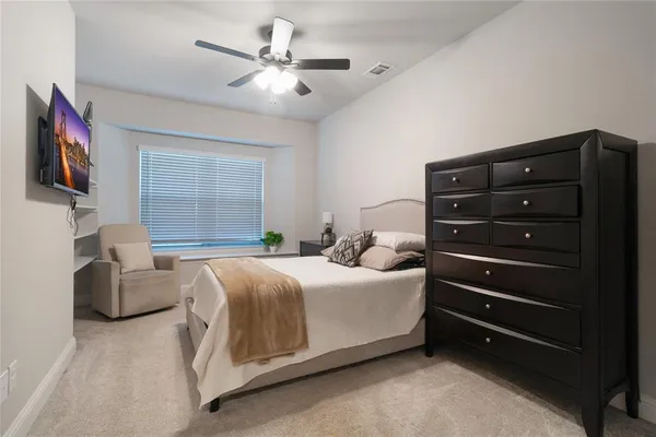 a bedroom with a bed dresser and a window
