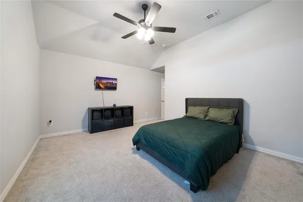 a bedroom with a bed and a ceiling fan
