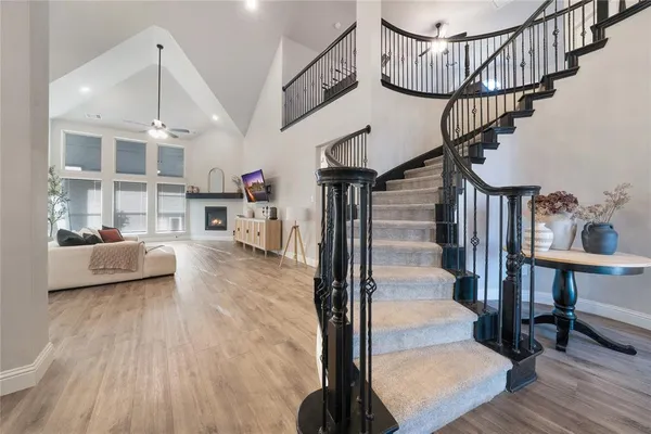 a view of entryway and hall with wooden floor