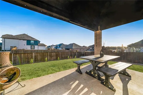 a view of a patio with a table chairs and a garden