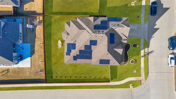 an aerial view of a house with a yard basket ball court and outdoor seating