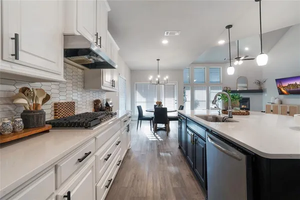 a kitchen with lots of counter space and stainless steel appliances