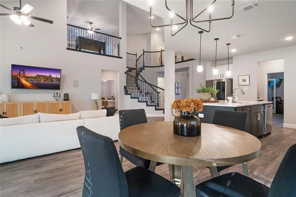 a dining room with furniture and wooden floor