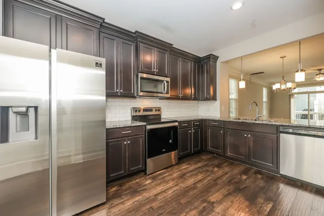 a large kitchen with cabinets and stainless steel appliances
