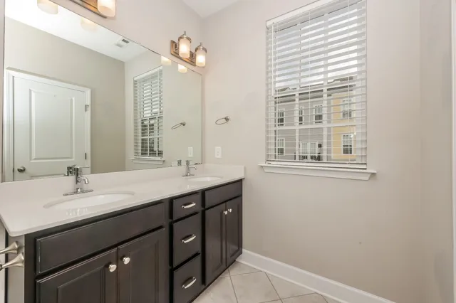 a bathroom with a sink double vanity and a mirror