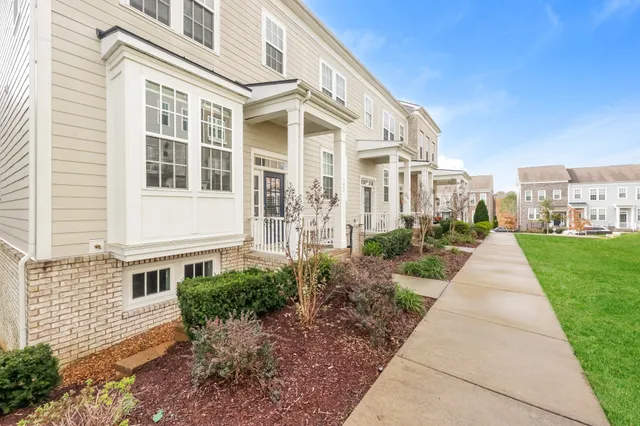a view of a brick house with a yard
