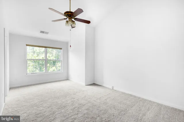 a bathroom with a sink a toilet and a window