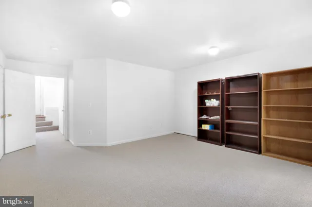 a view of an empty room with empty shelves
