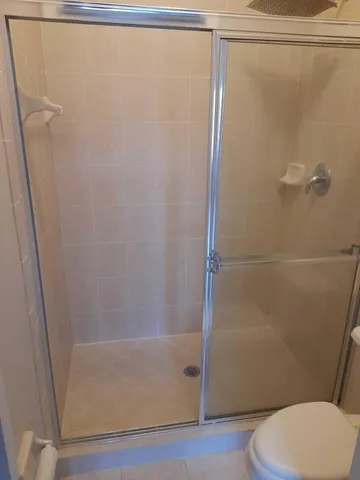 a bathroom with a shower and a toilet