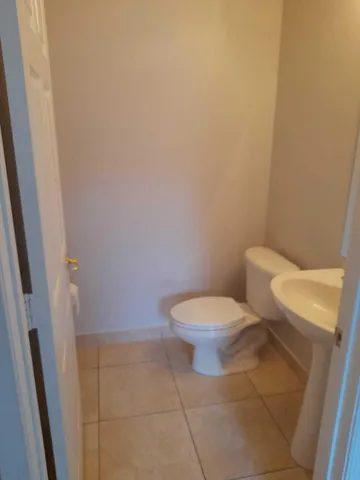 a white toilet sitting next to a white sink